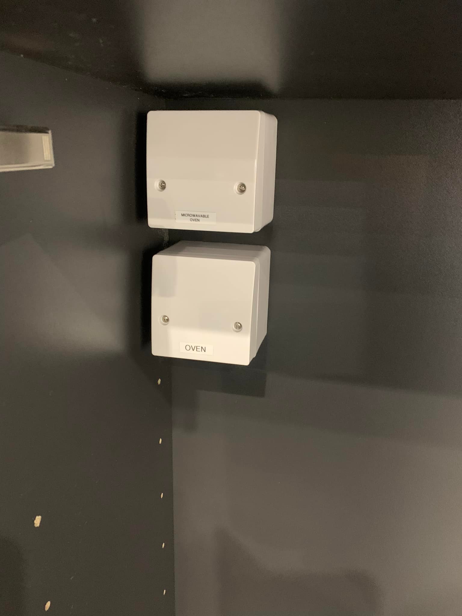 Fuse boxes for microwave and oven, mounted inside a cabinet
